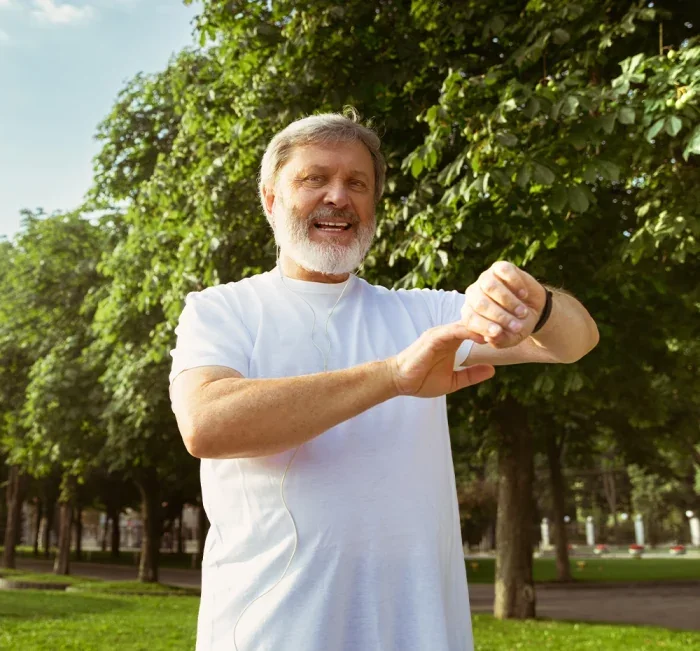 A man checking his watch outdoors, illustrating a consistent daily routine