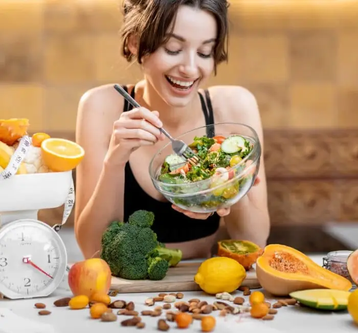 Fresh vegetables and fruit alongside a prepared salad